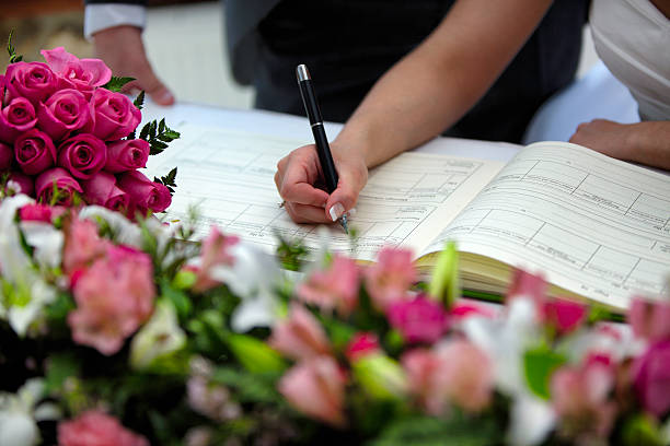 Bride and groom signing marriage certificate at Birmingham wedding