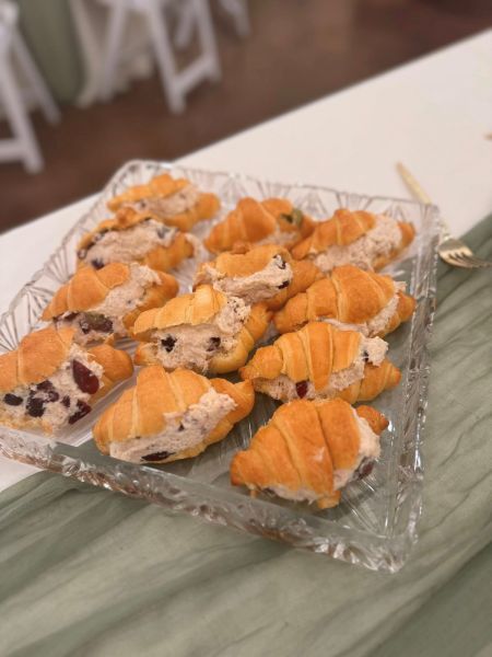 A crystal serving platter filled with signature mini croissants stuffed with savory chicken or tuna salad, perfect for elegant events and catering displays.